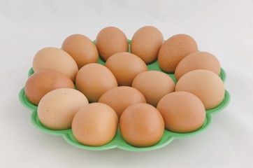 Fresh organic eggs in  basket on a light  background