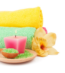 Obraz na płótnie Canvas Soft terry towels, bath salts, aroma candle and flowers for