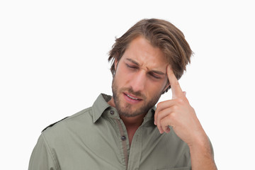 Man with headache touching his head