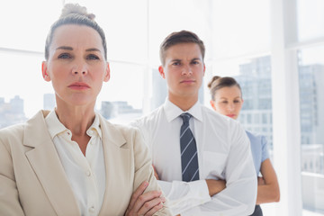 Serious attractive businesswoman standing with arms crossed