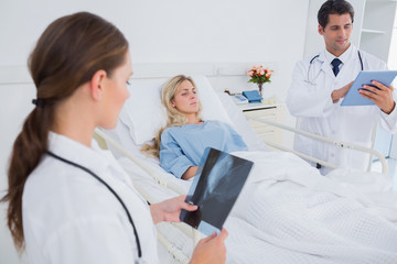 Doctors with xray and digital tablet