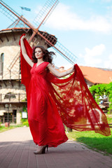 Naklejka premium Beautiful woman in a bright red dress