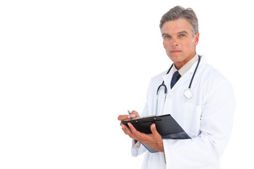 Man doctor writing on clipboard with pen