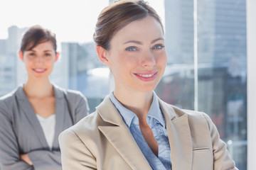 Happy businesswomen with arms crossed