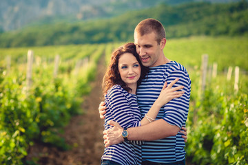 Couple in striped shirts in the vineyard