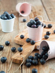 Fresh blueberries in small bucket. Selective focus