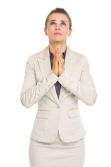 Portrait of business woman praying