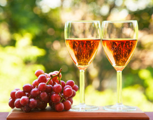 Glass of pink wine and grape