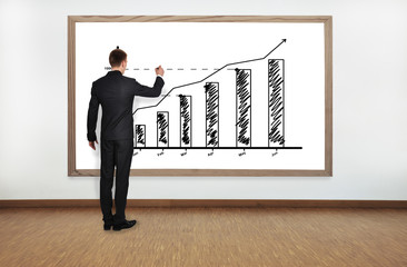 businessman drawing graph