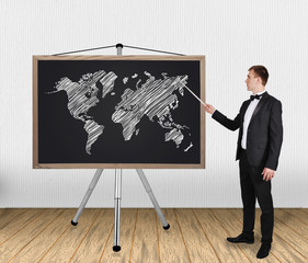 businessman pointing at world map