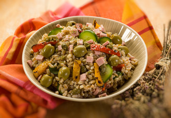 spelt sald with vegetables and ham, selective focus