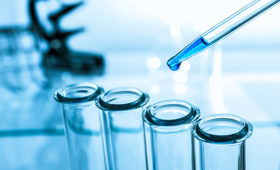 pipette and test tube on blue background - 53595321