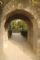 Brick arch in the gardens of the Alcazar of Seville, Spain