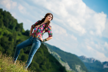 beautiful woman in jeans standing on the grass