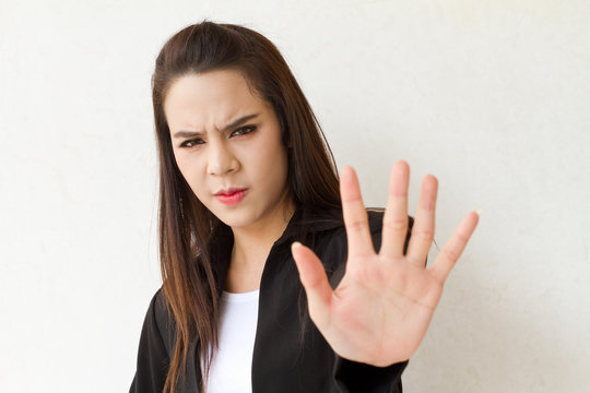 woman in business suit showing stop hand gesture