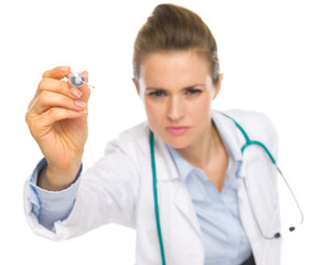 Closeup on syringe in hand of doctor woman