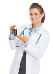 Happy doctor woman holding medicine bottle