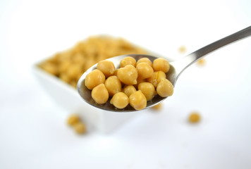 Chickpeas in small white dish with spoon