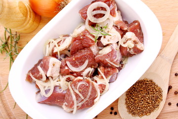 Lamb marinated with onion, spices and herbs in bowl