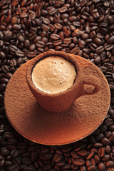 Cup of espresso  on coffee beans background