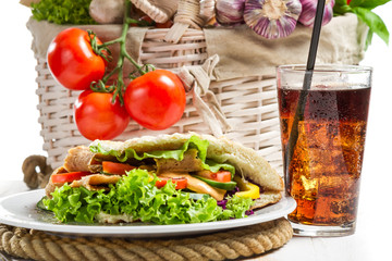 Kebab made of vegetables and meat served with cold cola