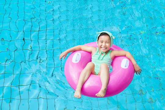 happy little girl in the swimming pool