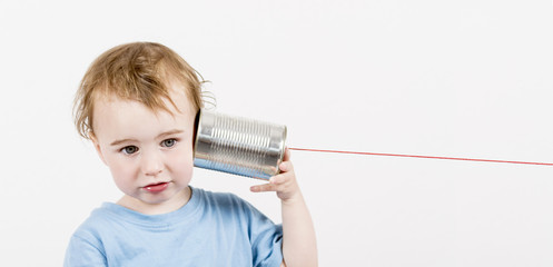 child with tin can phone