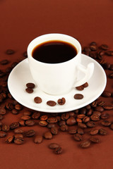 Cup of strong coffee on brown background
