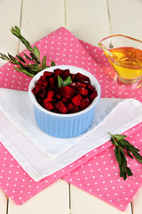 Sliced beetroot on bowl on wooden table close-up