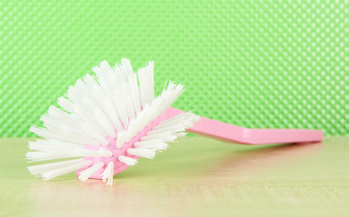 Toilet brush on green background