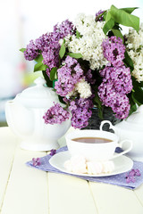 Composition with beautiful lilac flowers, tea service