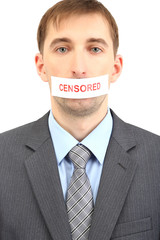 Young businessman with a band on his mouth isolated on white