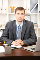 Young businessman in office at his workplace
