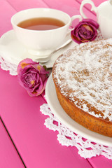 Delicious poppy seed cake with cup of tea on table close-up