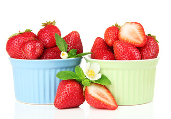 Ripe sweet strawberries in bowls, isolated on white