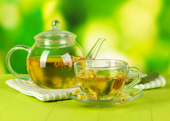 Kettle and cup of tea with linden