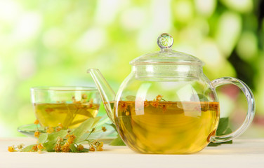 Kettle and cup of tea with linden