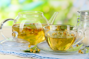 Kettle and cup of tea with linden