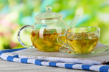 Kettle and cup of tea with linden