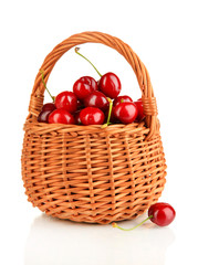 Fototapeta na wymiar Ripe red cherry berries in basket isolated on white