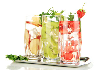 Glasses of fruit drinks with ice cubes isolated on white
