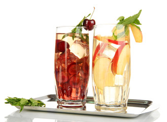 Glasses of fruit drinks with ice cubes isolated on white