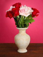 Beautiful bouquet of roses in vase with gift