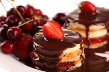 Tasty biscuit cakes with chocolate and berries