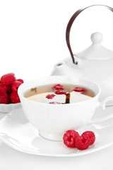 Cup of berry tea isolated on white