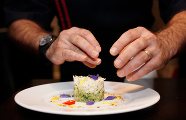 Obraz na płótnie Canvas Chef is decorating appetizer with flowers
