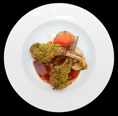 Grilled rack of lamb with pistachio in plate, isolated on black