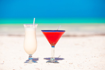 two cocktails: pina colada and strawberry margarita on white