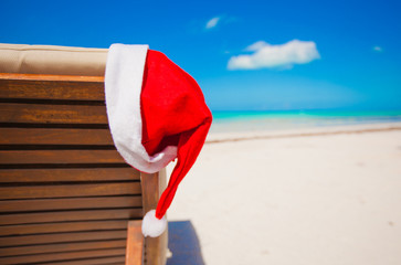 Close-up santa hat on chair longue on tropical caribbean beach