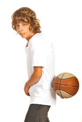 Teen boy playing basketball